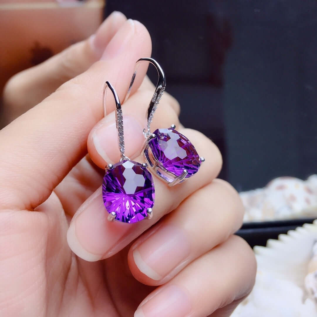 Elegant women's sterling silver earrings with large purple amethyst stones and delicate inlay design