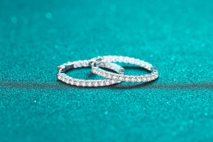 Fashion sterling silver earrings for women with sparkling stones on turquoise background