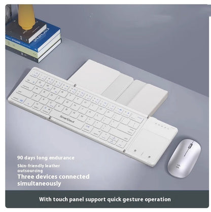 White folding Bluetooth keyboard with wireless mouse and touch panel on gray desk
