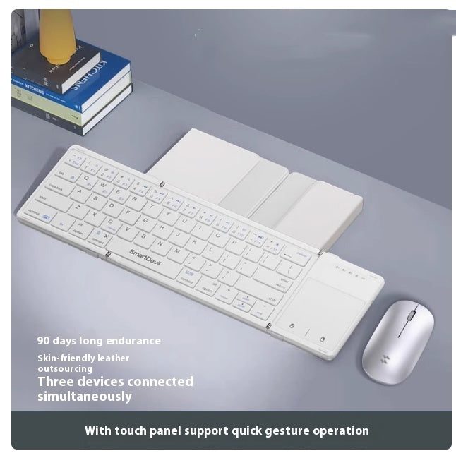White folding Bluetooth keyboard with wireless mouse and touch panel on gray desk