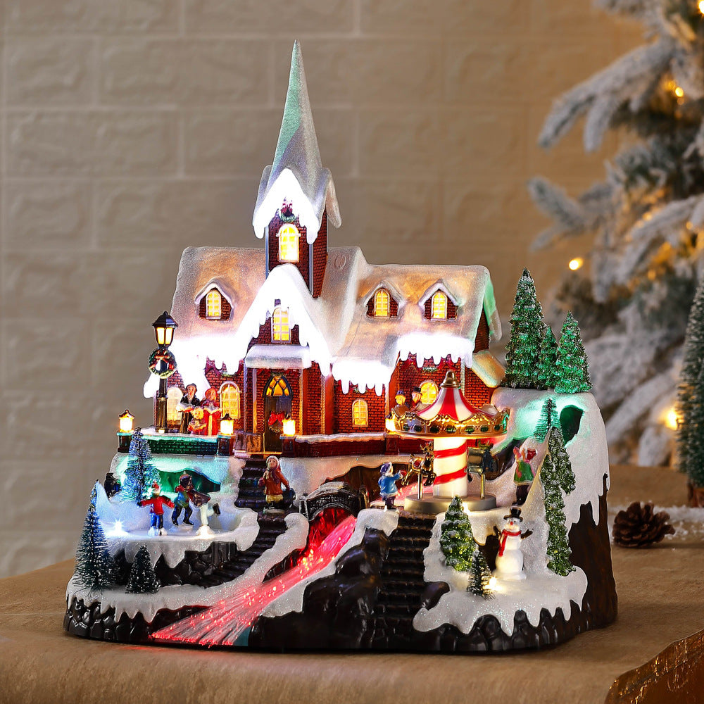 European style mountaintop church Christmas decoration with snow and lights