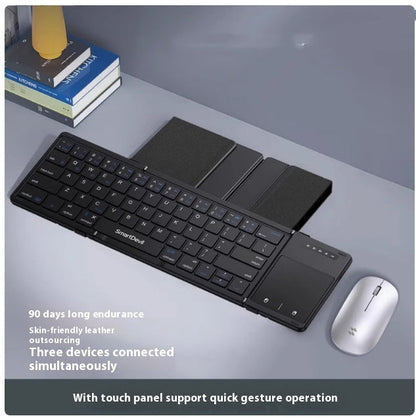 Compact folding Bluetooth keyboard with touchpad and wireless mouse on desk