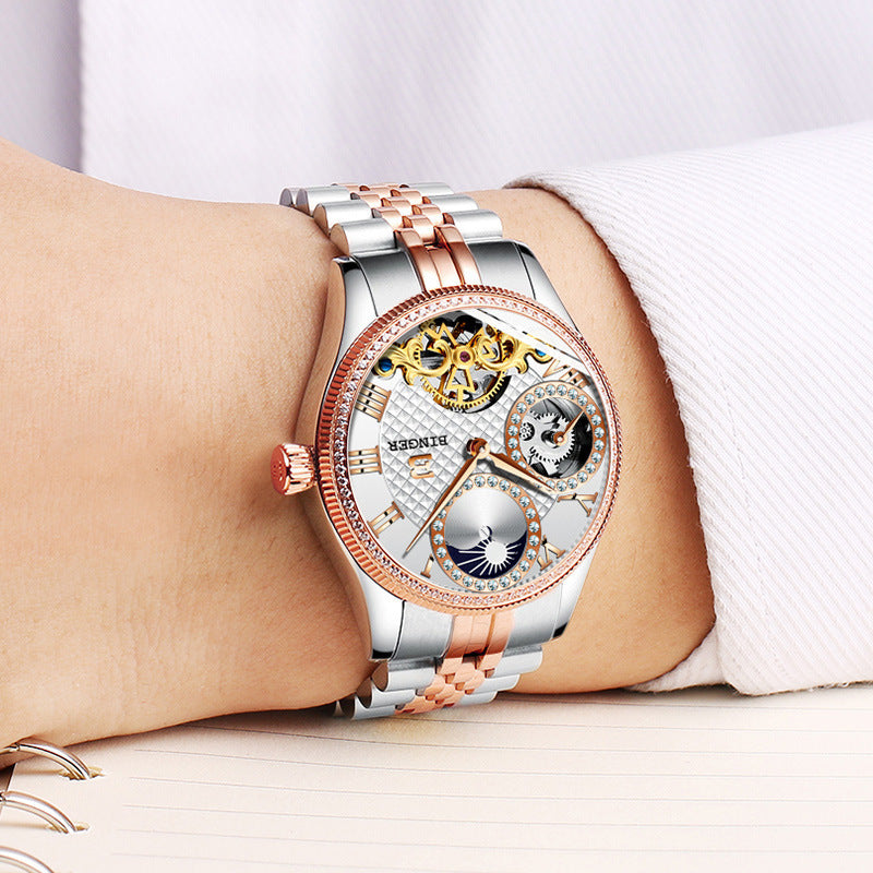 Men's automatic mechanical skeleton watch with stainless steel two-tone rose gold and silver band, transparent dial, and waterproof design